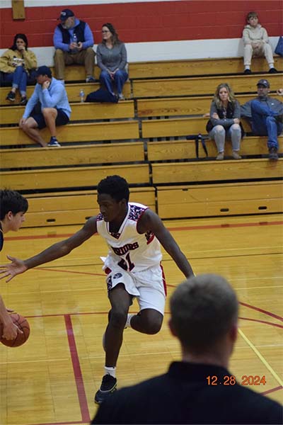 boy in white trying to steal the ball