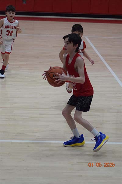 boy in red passing