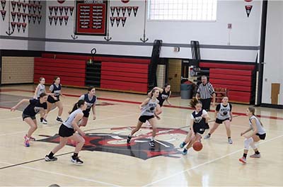 Girls basketball running up the court
