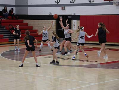 Girls in gray reaching for a pass