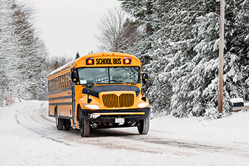 School bus driving on a snowy day