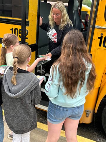 Students getting on a bus
