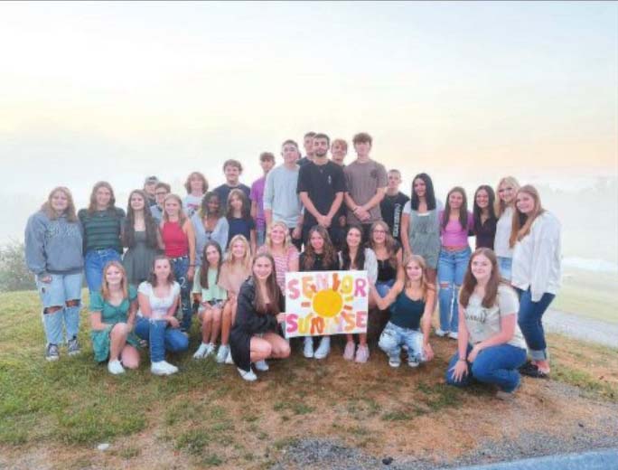 Students gathered together at sunrise