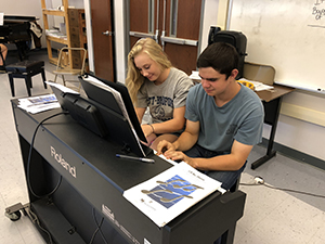 Two students sitting at a piano