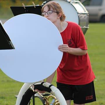 student setting up their large horn