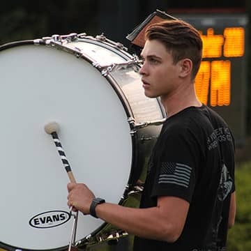 student playing a drum