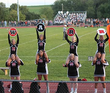 cheer team spelling out Warriors