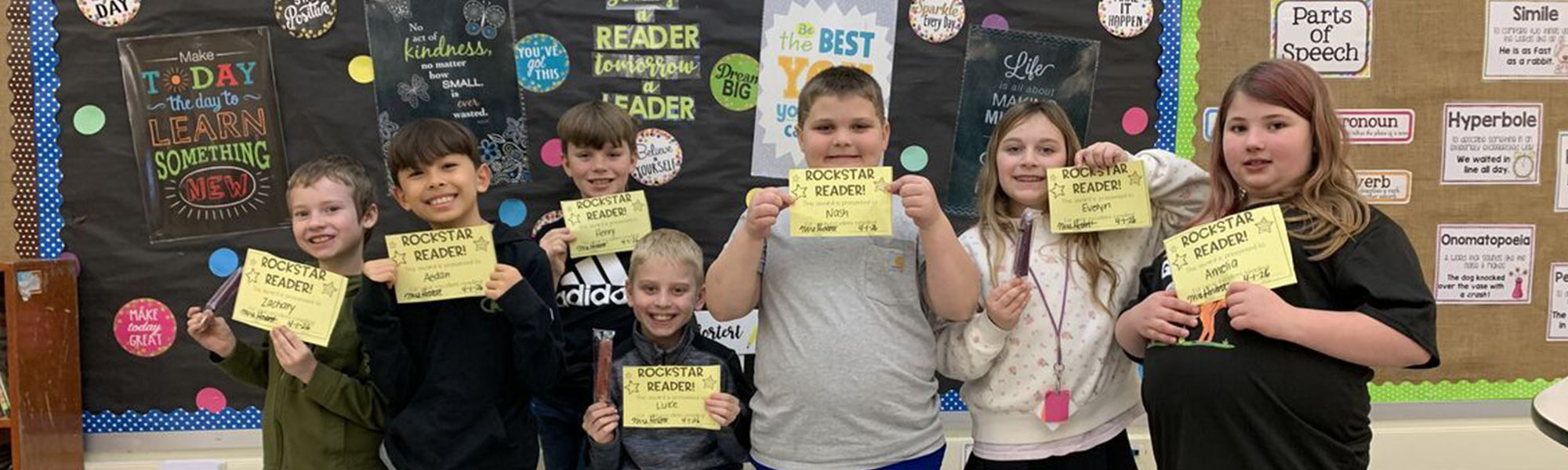 Students holding up their certificates for being Rockstar Readers!