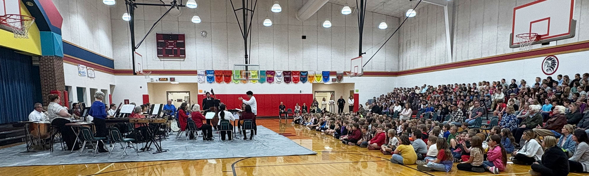 Students enjoying a music assembly in the gym