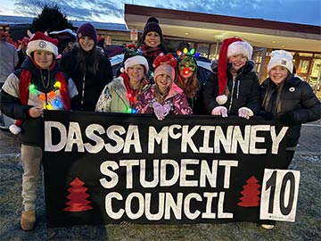 Student council members posing for a picture outside front of school