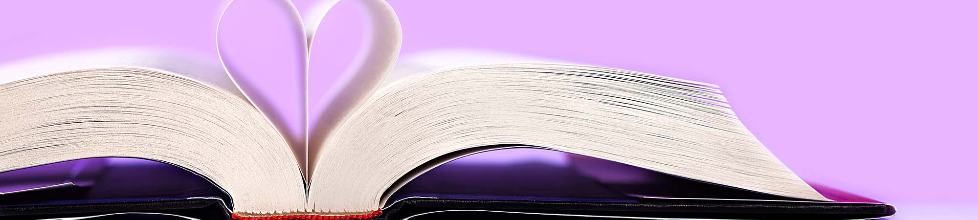 Big book opened with pages folded into a heart