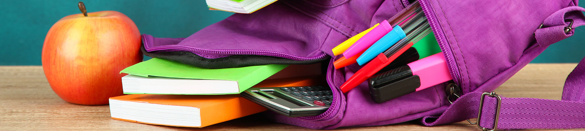 Purple backpack with school supplies