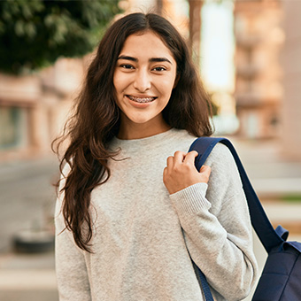 Happy student with backpack smiling for the camera