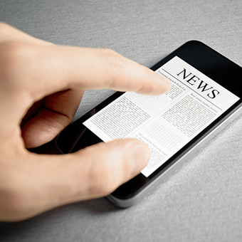 Parent reading school news on her mobile phone