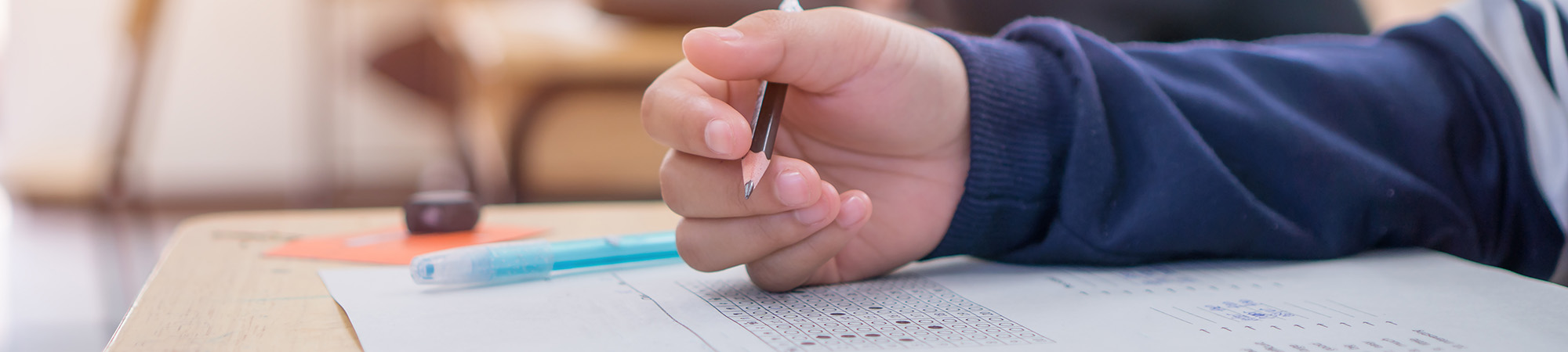 Student taking a test at his desk