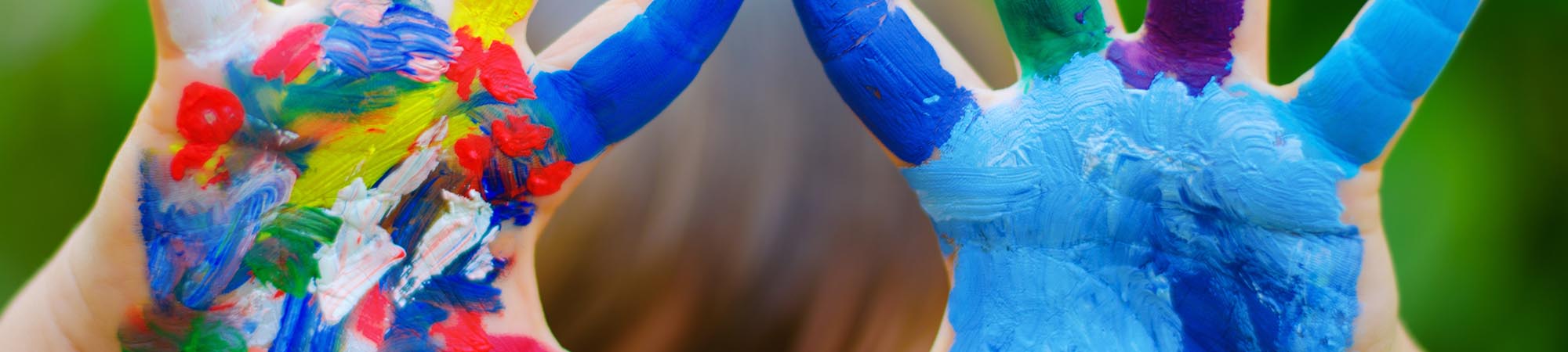 Small hands painted with colorful paint