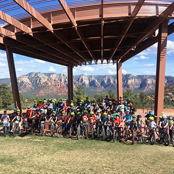 Group of students on bikes taking a group photo