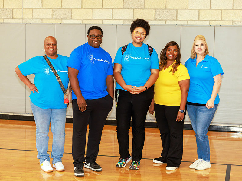 Five happy staff members at a fun event