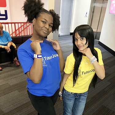 Two happy school girls posing for a picture