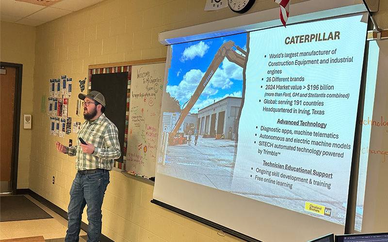 Person giving a presentation on Caterpillar construction equipment