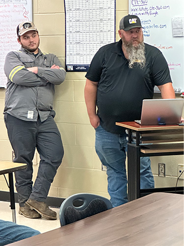 Two people in front of the class