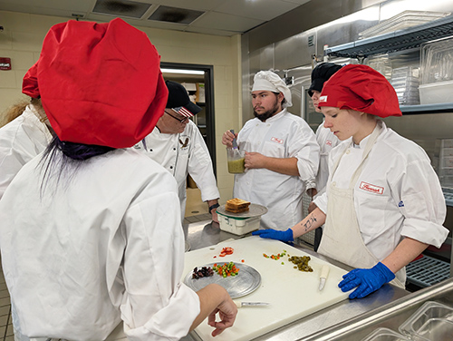 Group of culinary students working in the kitchen