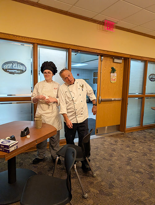 Chef and culinary student posing for a picture