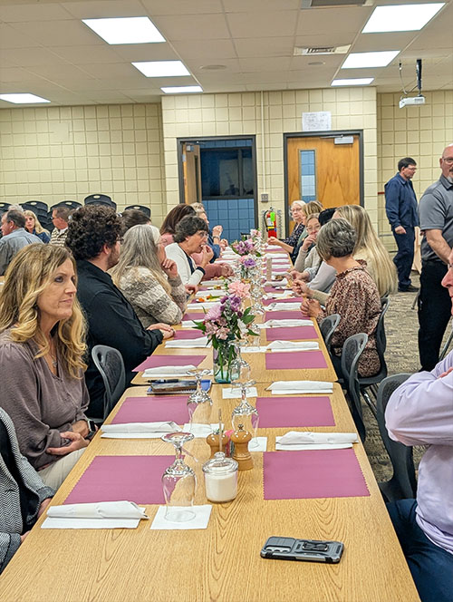 Annual Occupational Advisory Committee dinner participants sitting at a long table