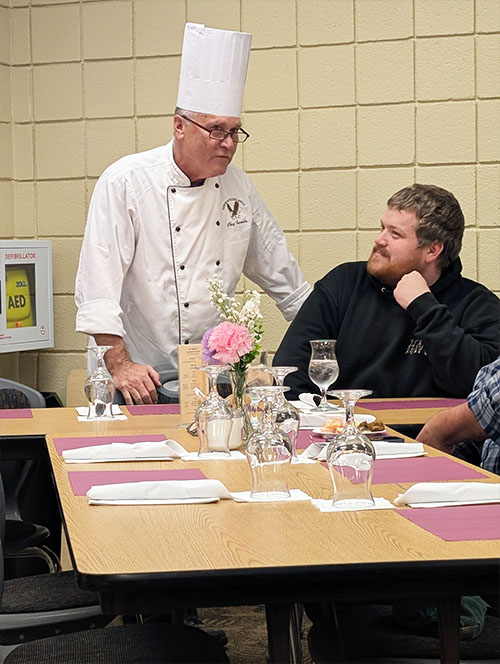 Chef Paul Farmelo talking with a dinner participant