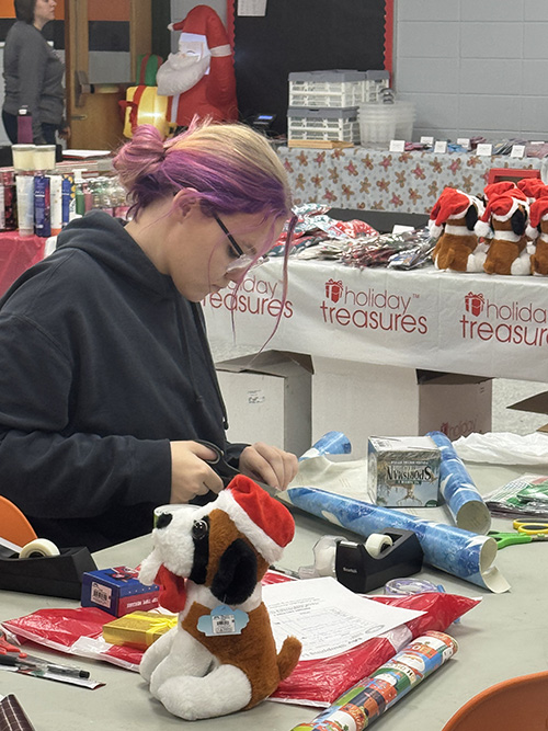 Early Childhood Education student helping the Port Allegany School District Elementary Boosters with Santa's Secret Shop