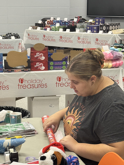 Student helping with Santa's Secret Shop