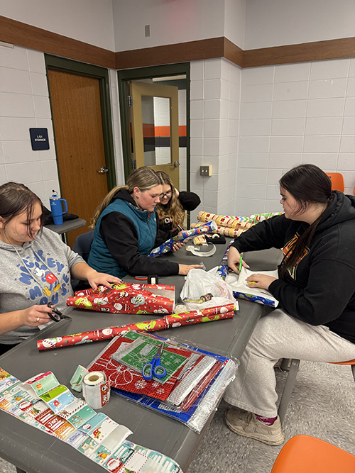 Students helping the Port Allegany School District Elementary Boosters with Santa's Secret Shop wrapping