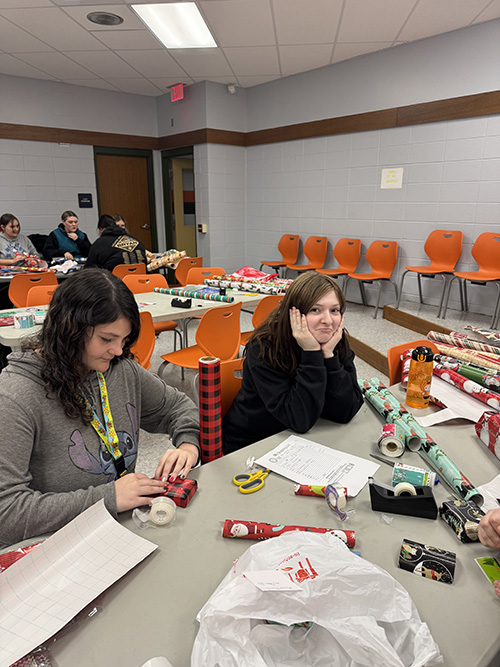 Early Childhood Education students helping the Port Allegany School District Elementary Boosters by wrapping gifts