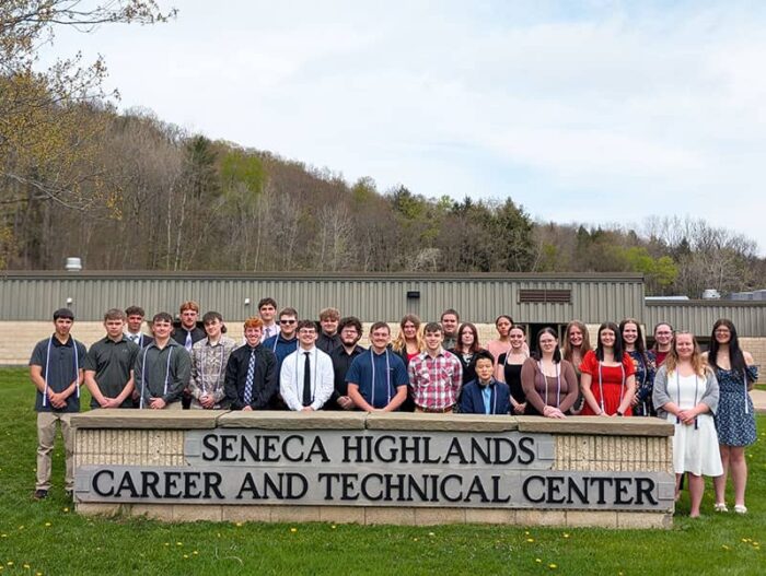 Seneca Highlands Career and Technical Center National Technical Honor Society Induction Ceremony members outside next to school sign