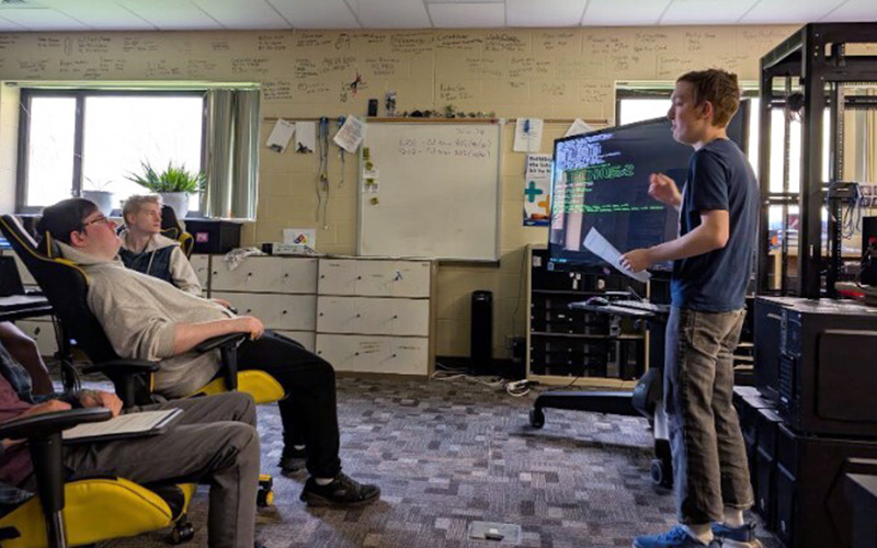 Richard Wojcik presenting his self-made computer operating system to his classmates