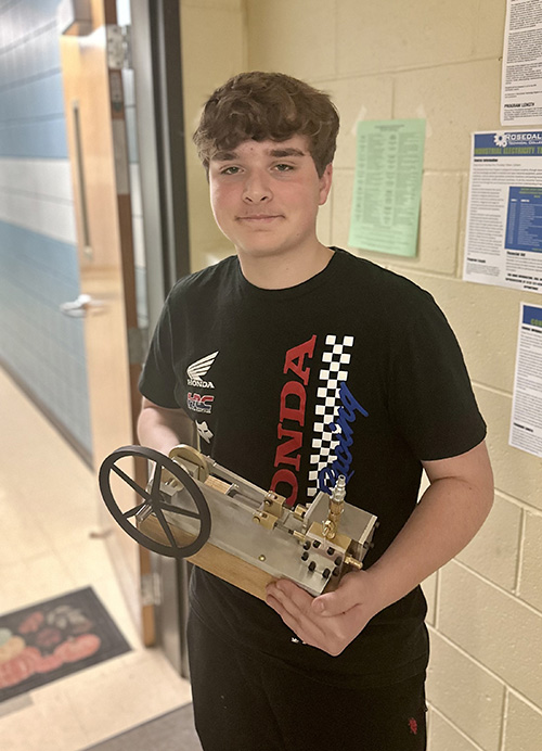 Kinley Setzer posing with steam engine
