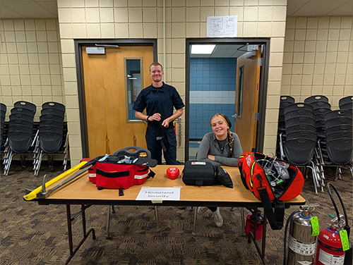 Two fire safety representatives behind an information table