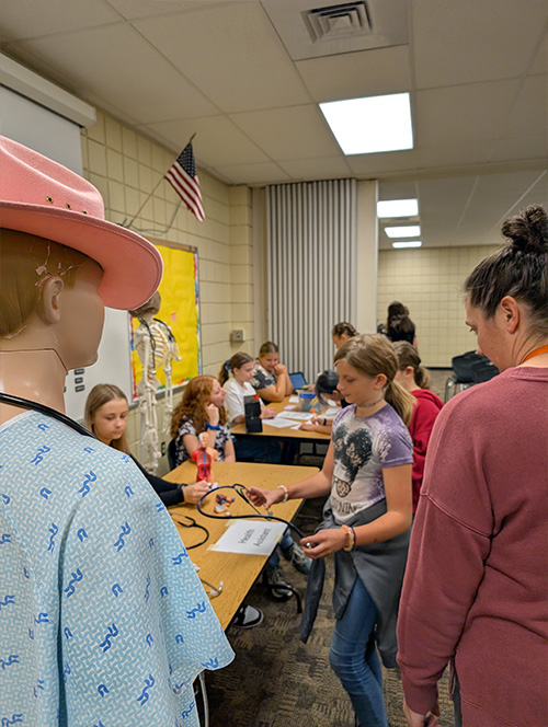 Students around a program table