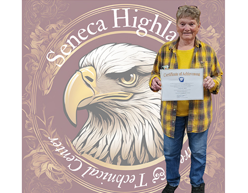 Debbie Bird proudly holding certificate