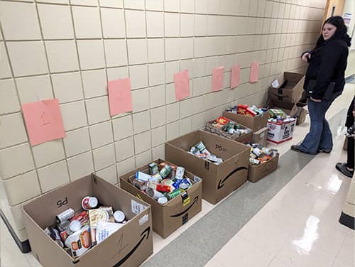 School hallway with boxes of donations