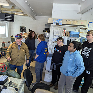 students looking at building equipment
