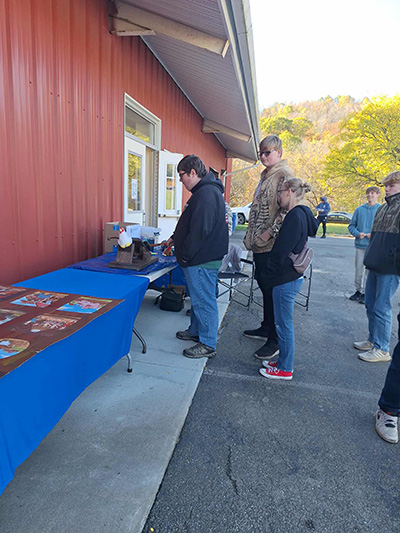 Students outside at table display