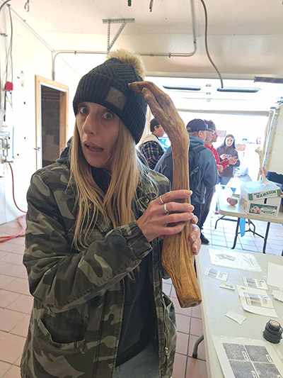 Student posing with an item shaped like an arm and hand