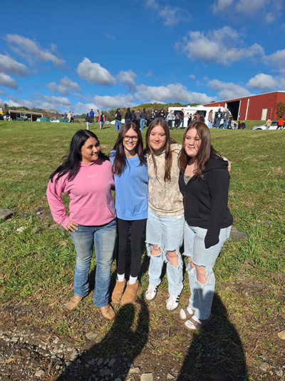 Four girls posing together outside