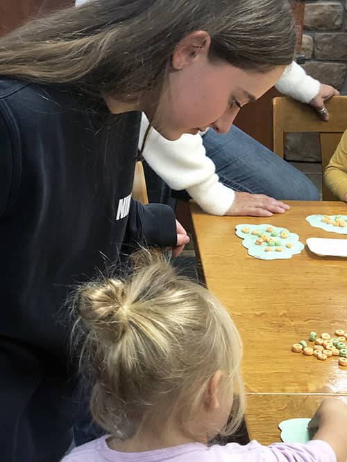 Seneca Highlands CTC student working on a fun activity with a little one.