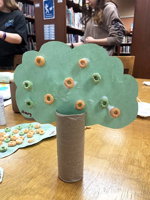Paper tree craft displayed on the library desk