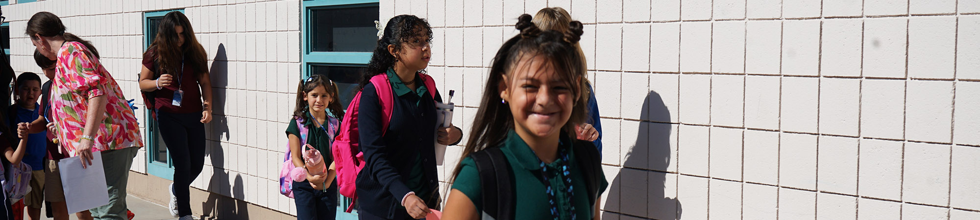 Happy students walking in between classes on campus