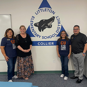 Principal posing for a picture with community members