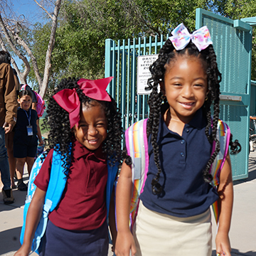 Two happy girls dressed up for school