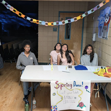 Four students manning the Spring Dance ticket table